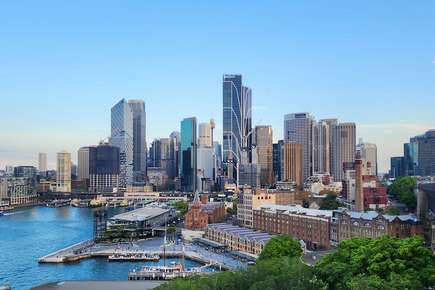 City skyline with lots of high rise buildings, situated by the water with a dock in front